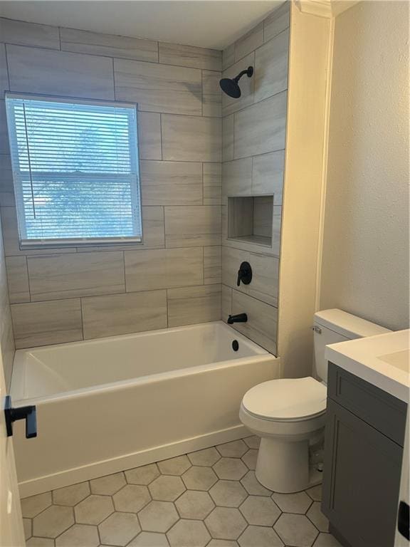 full bathroom with vanity, tiled shower / bath combo, toilet, and tile patterned flooring