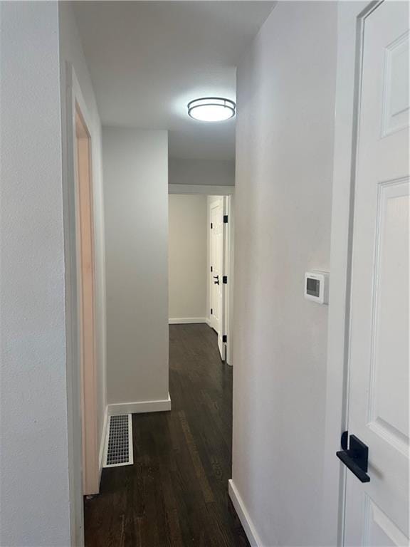 hallway with dark wood-type flooring