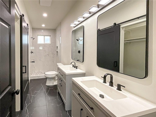 bathroom with vanity, toilet, and a shower with door