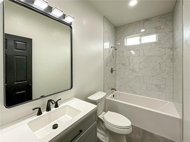 full bathroom featuring tile patterned flooring, tiled shower / bath, toilet, and vanity