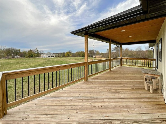 wooden deck featuring a lawn