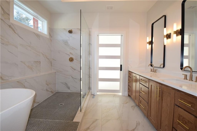 bathroom featuring shower with separate bathtub, tile walls, and vanity