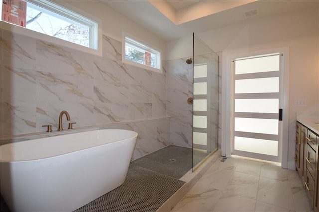 bathroom with vanity and separate shower and tub