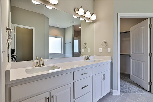 bathroom featuring tile patterned flooring and vanity