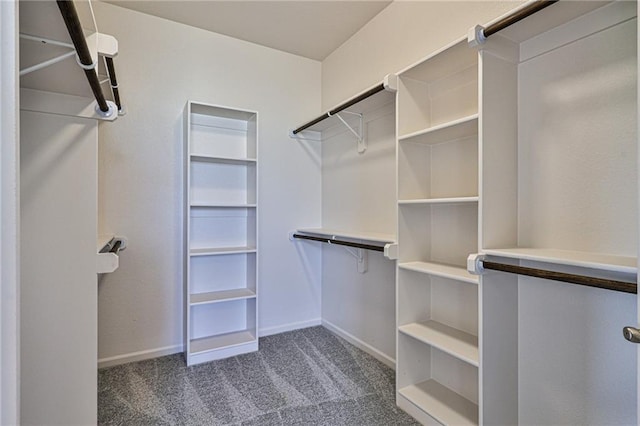 spacious closet featuring dark carpet