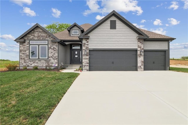 view of front of property featuring a garage and a front yard