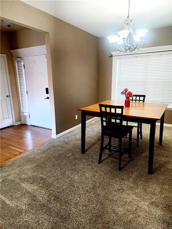 dining room with a notable chandelier and dark hardwood / wood-style floors