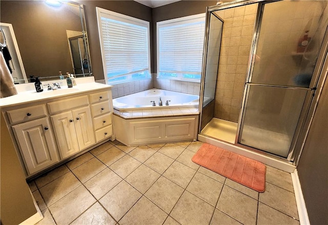 bathroom featuring tile patterned floors, vanity, and shower with separate bathtub