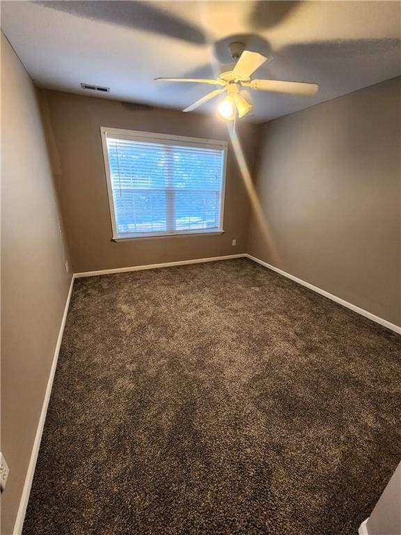 empty room with carpet flooring and ceiling fan