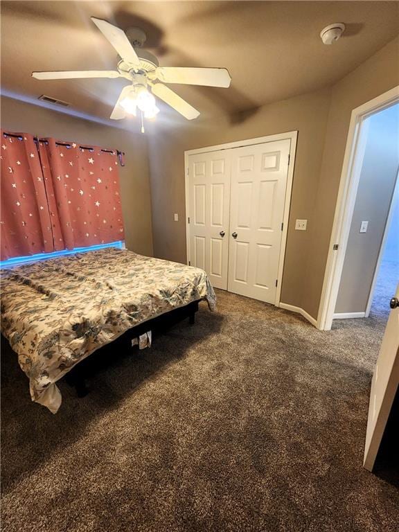 bedroom with ceiling fan, a closet, and carpet