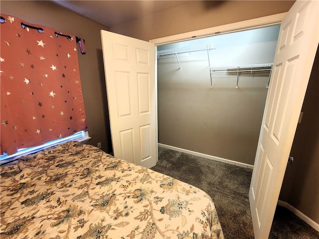 unfurnished bedroom with a closet and dark carpet