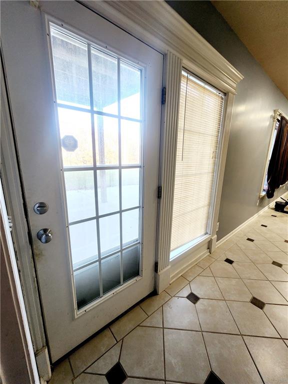 doorway featuring light tile patterned floors