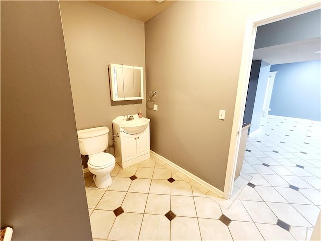 bathroom featuring tile patterned flooring, vanity, and toilet