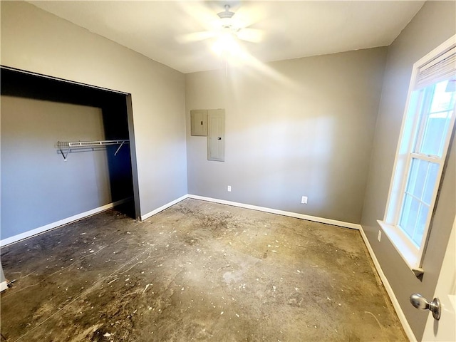 unfurnished bedroom with electric panel, ceiling fan, and a closet