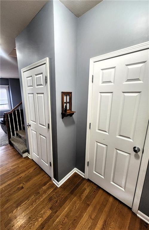 corridor with dark wood-type flooring