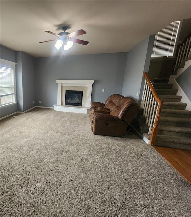 unfurnished living room featuring ceiling fan and wood-type flooring