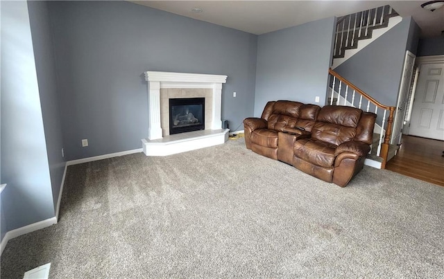 living room featuring hardwood / wood-style flooring and a tiled fireplace