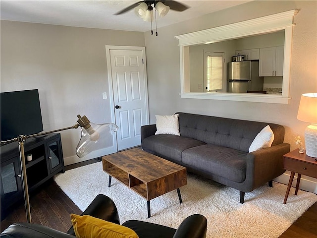 living room with dark hardwood / wood-style floors and ceiling fan