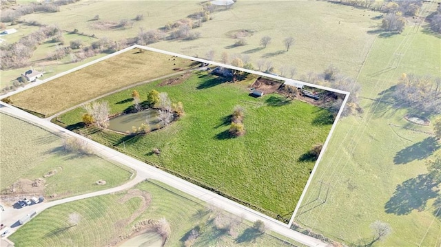 birds eye view of property with a rural view