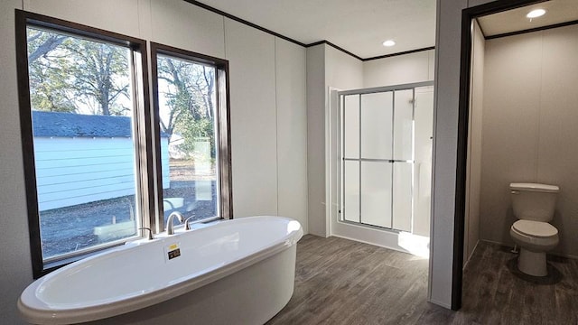 bathroom featuring separate shower and tub, toilet, hardwood / wood-style floors, and ornamental molding