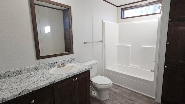 full bathroom with vanity, hardwood / wood-style flooring, toilet, and shower / washtub combination