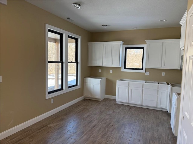 kitchen with white cabinetry and dark wood-type flooring