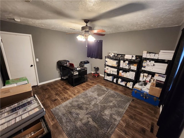 office area featuring ceiling fan, dark hardwood / wood-style floors, and a textured ceiling