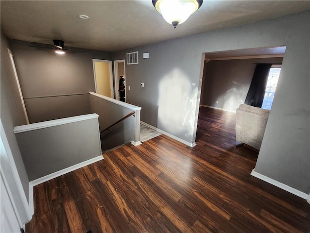 spare room featuring ceiling fan and dark hardwood / wood-style flooring