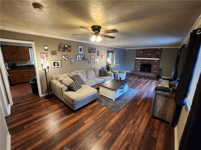 2716 N 10th St, Independence, KS 67301 - living area with a textured ceiling, dark wood finished floors, crown molding, a ceiling fan, and a fireplace