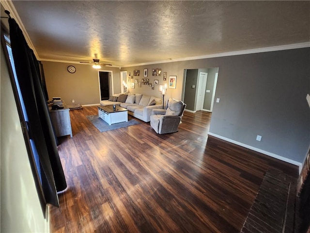 unfurnished living room featuring a textured ceiling, dark hardwood / wood-style flooring, ceiling fan, and crown molding