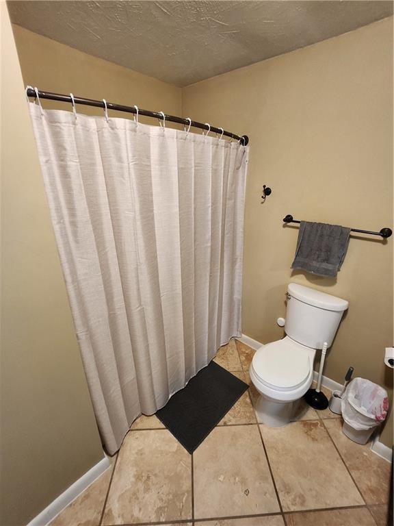 bathroom with walk in shower, tile patterned flooring, toilet, and a textured ceiling