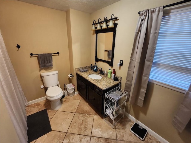 2716 N 10th St, Independence, KS 67301 - bathroom featuring vanity, toilet, tile patterned flooring, and baseboards