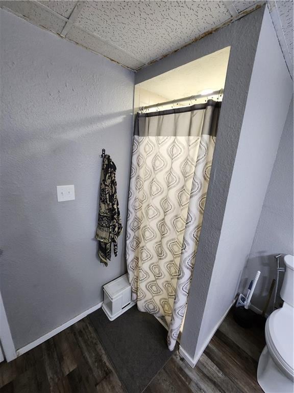 bathroom featuring hardwood / wood-style floors and toilet