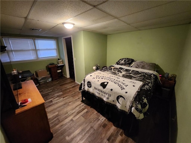 2716 N 10th St, Independence, KS 67301 - bedroom featuring wood finished floors and a drop ceiling