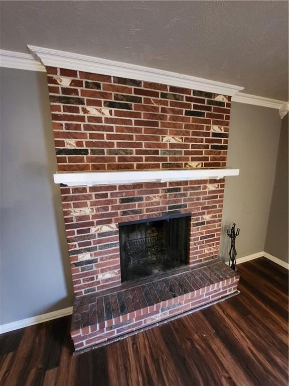 details featuring a brick fireplace, crown molding, and hardwood / wood-style floors