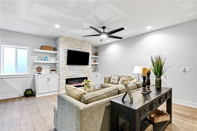 24912 W 98th Pl, Lenexa, KS 66227 - living room featuring ceiling fan, a stone fireplace, light wood-style floors, baseboards, and recessed lighting