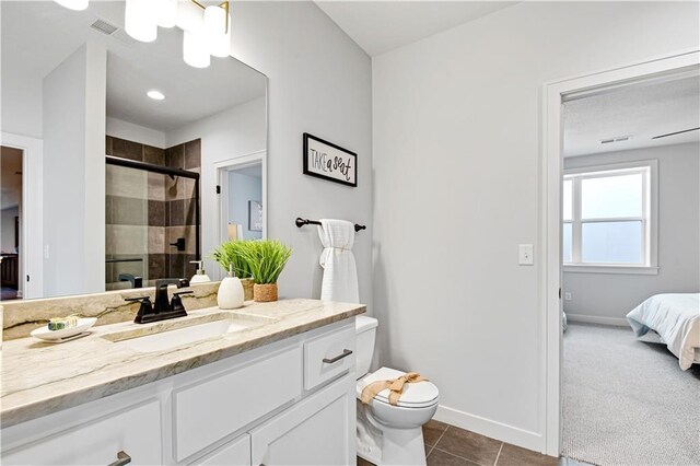 24912 W 98th Pl, Lenexa, KS 66227 - ensuite bathroom with a stall shower, baseboards, toilet, tile patterned floors, and vanity
