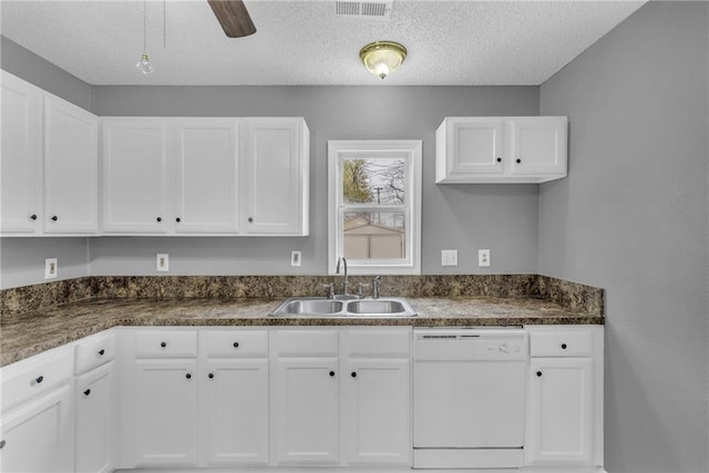 kitchen featuring white cabinetry, sink, ceiling fan, white dishwasher, and a textured ceiling