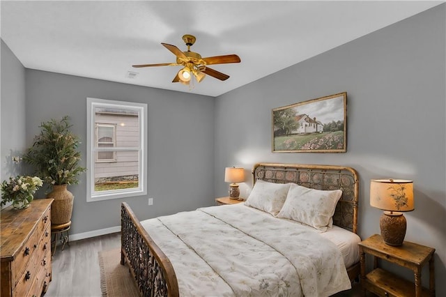 bedroom featuring dark hardwood / wood-style flooring and ceiling fan