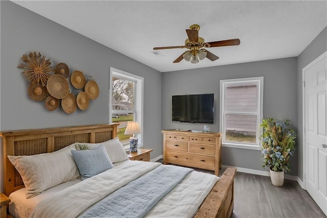 bedroom featuring hardwood / wood-style floors and ceiling fan