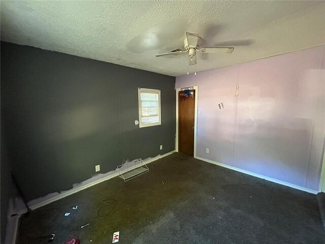 empty room with a textured ceiling and ceiling fan