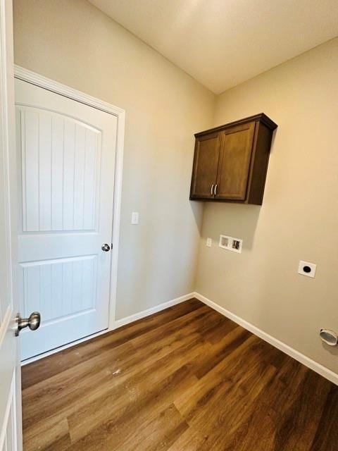 laundry area with electric dryer hookup, washer hookup, hardwood / wood-style flooring, and cabinets