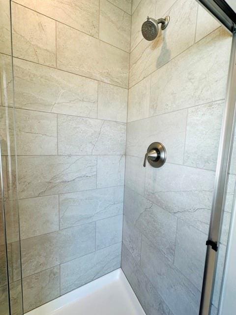 bathroom with tiled shower