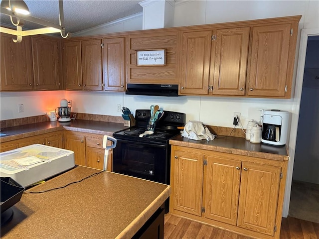 kitchen featuring light hardwood / wood-style floors, a textured ceiling, black range with electric stovetop, vaulted ceiling, and exhaust hood