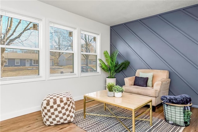 living area featuring plenty of natural light and hardwood / wood-style floors