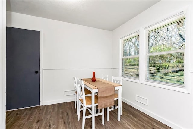 dining space featuring dark hardwood / wood-style flooring