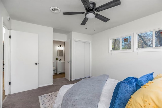 carpeted bedroom featuring ceiling fan, a closet, and ensuite bathroom