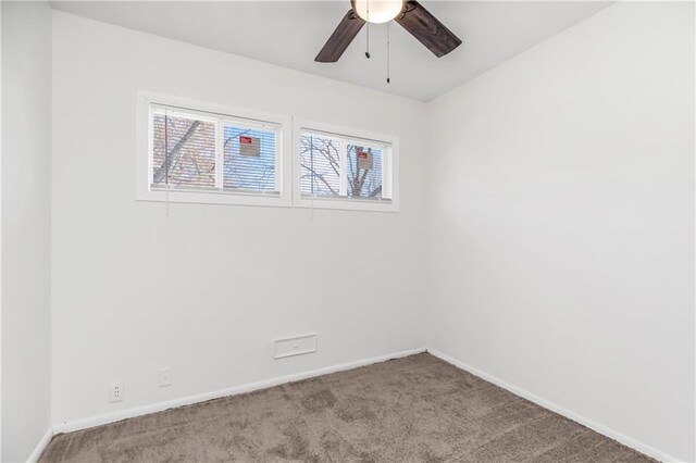 spare room featuring ceiling fan and light carpet