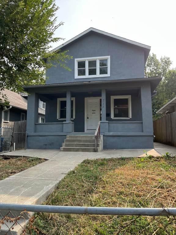 711 N 18th St, Kansas City, KS 66102 - bungalow-style home with stucco siding and covered porch