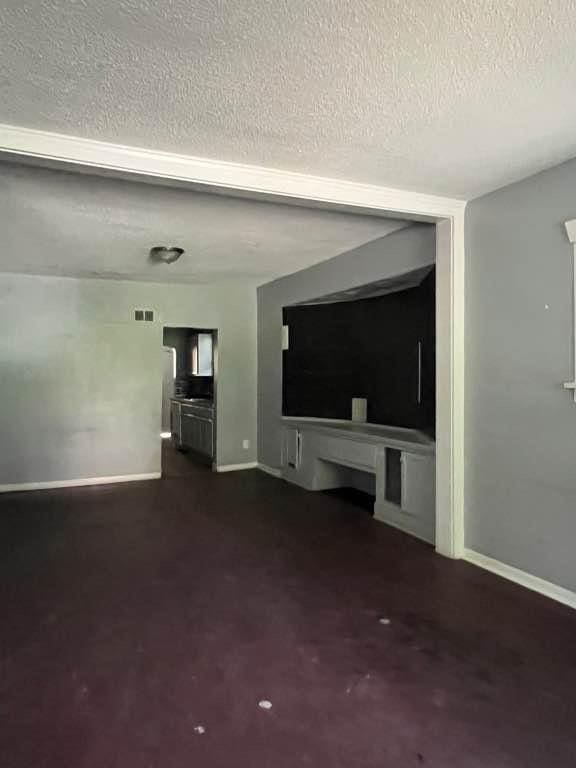 unfurnished living room with a textured ceiling